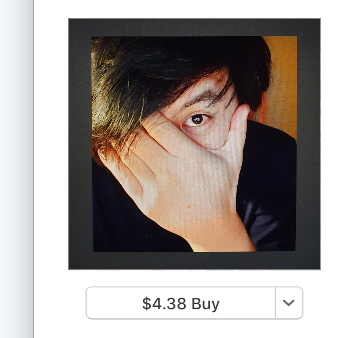 Close up of Jon Tjhia with his hand covering his face apart from one eye, which is looking to camera, and a button underneath that says '$4.38 Buy'