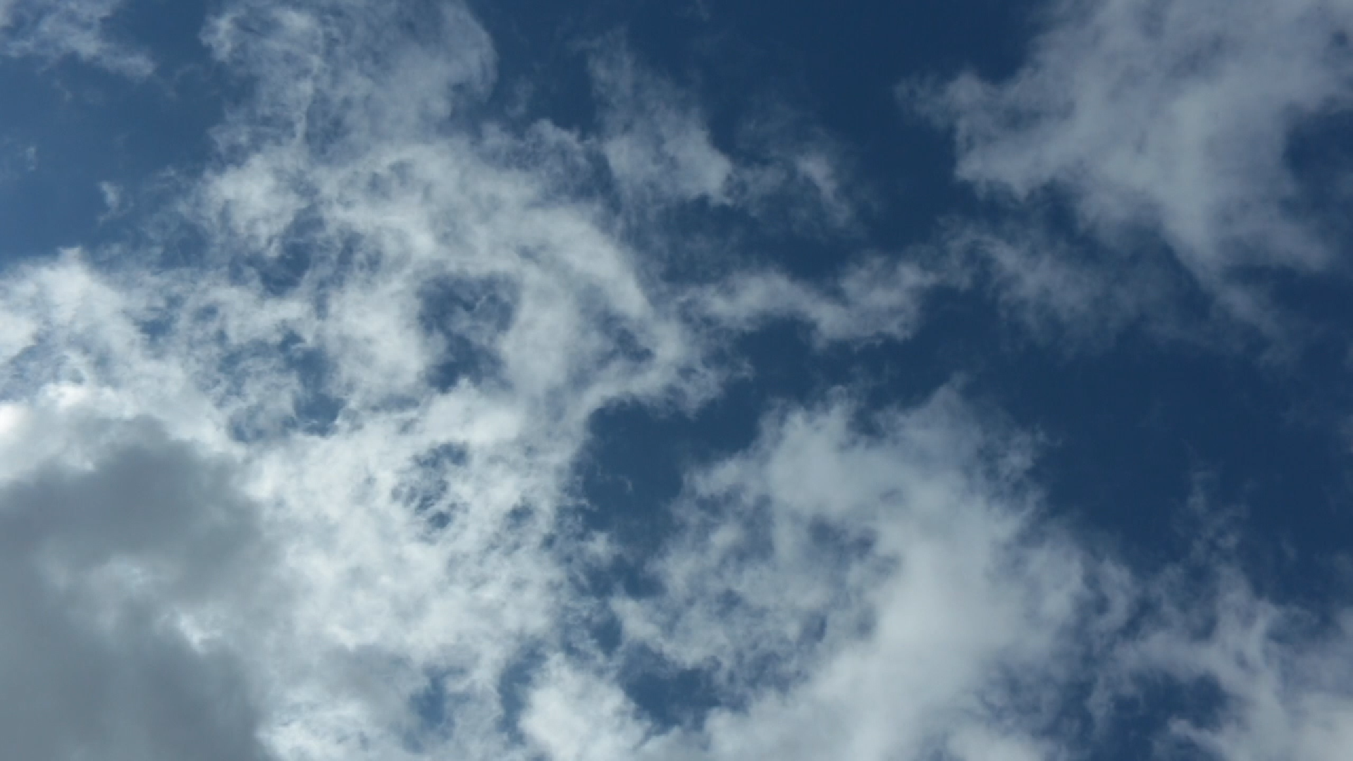 Still of lightly clouded blue sky from Kiernan Ironfield's Breath